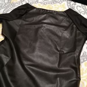 Brand new shirt that has leather on the front